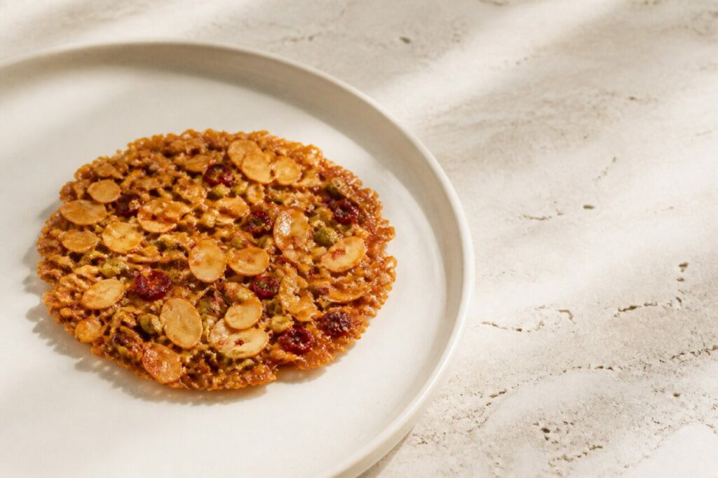 Hazelnut pieces stud the crisp Florentine biscuit