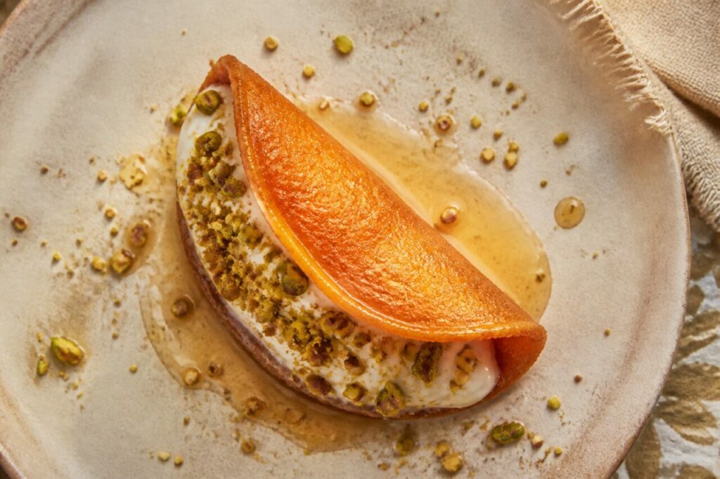 The qatayef asafiri half-moon holds a generous creamy centre