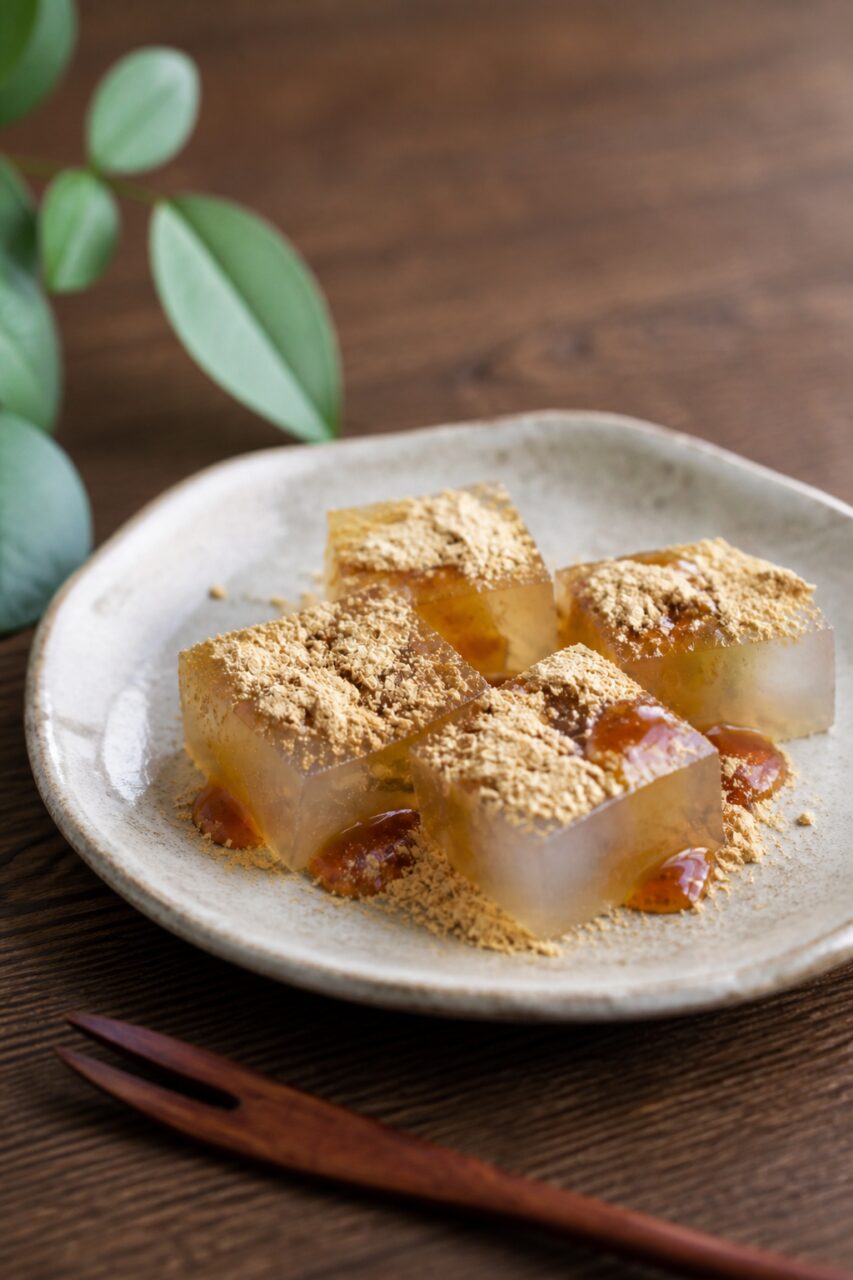 Amber syrup gathers between the powdered kuzumochi pieces