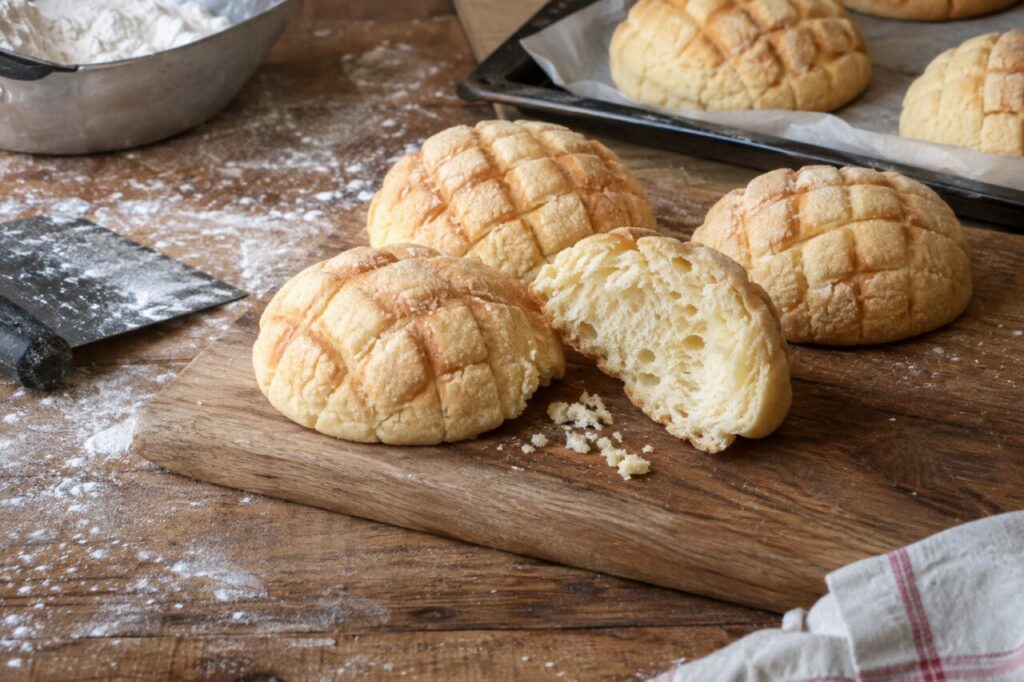 Pale crumb inside an opened Japanese melon pan on the bench