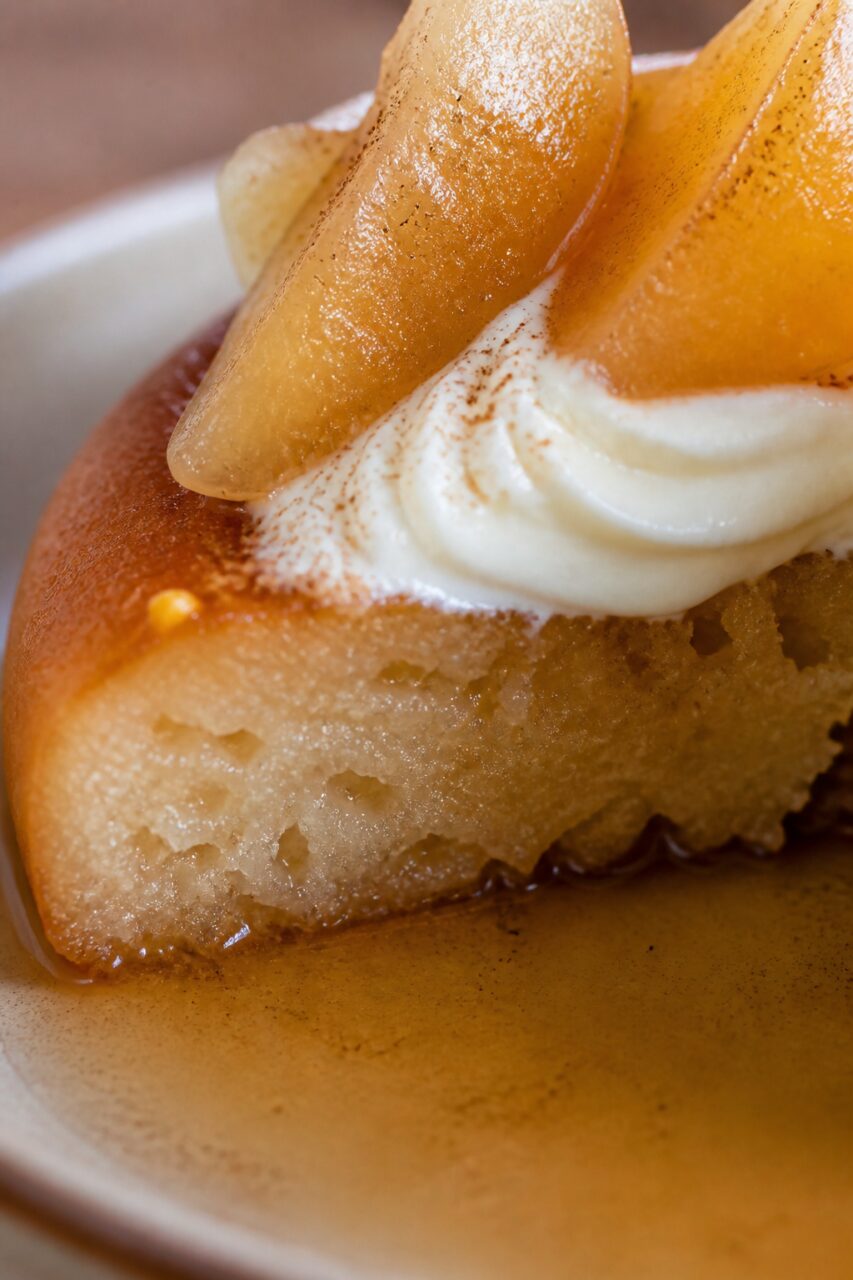 Syrup-soaked crumb of the cut poached pear savarin