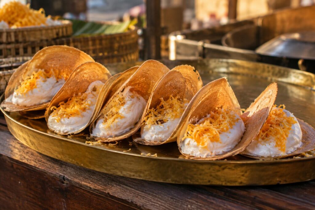 Thai market tray of crisp khanom buang with coconut meringue