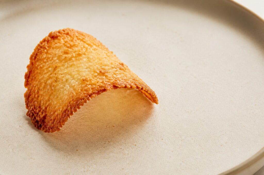 Wafer-thin toasted coconut tuile combines a golden colour with a crisp bite