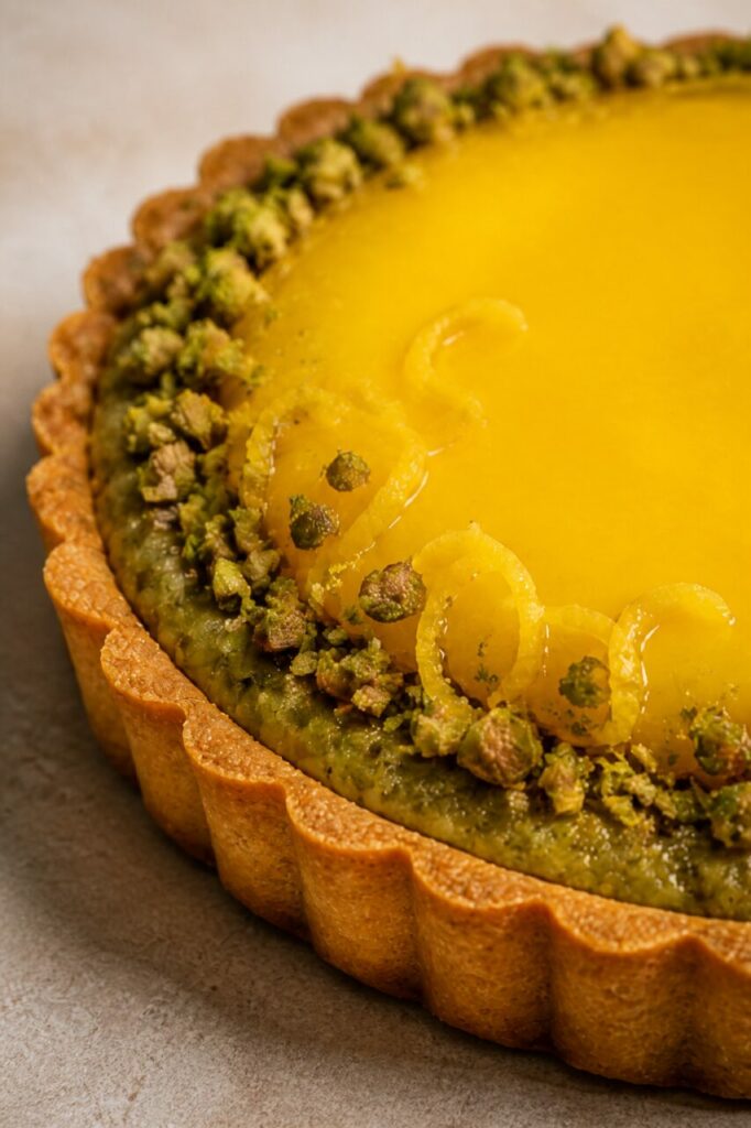Tiras de casca cristalizada enfeitam a tarte de limão e pistácio